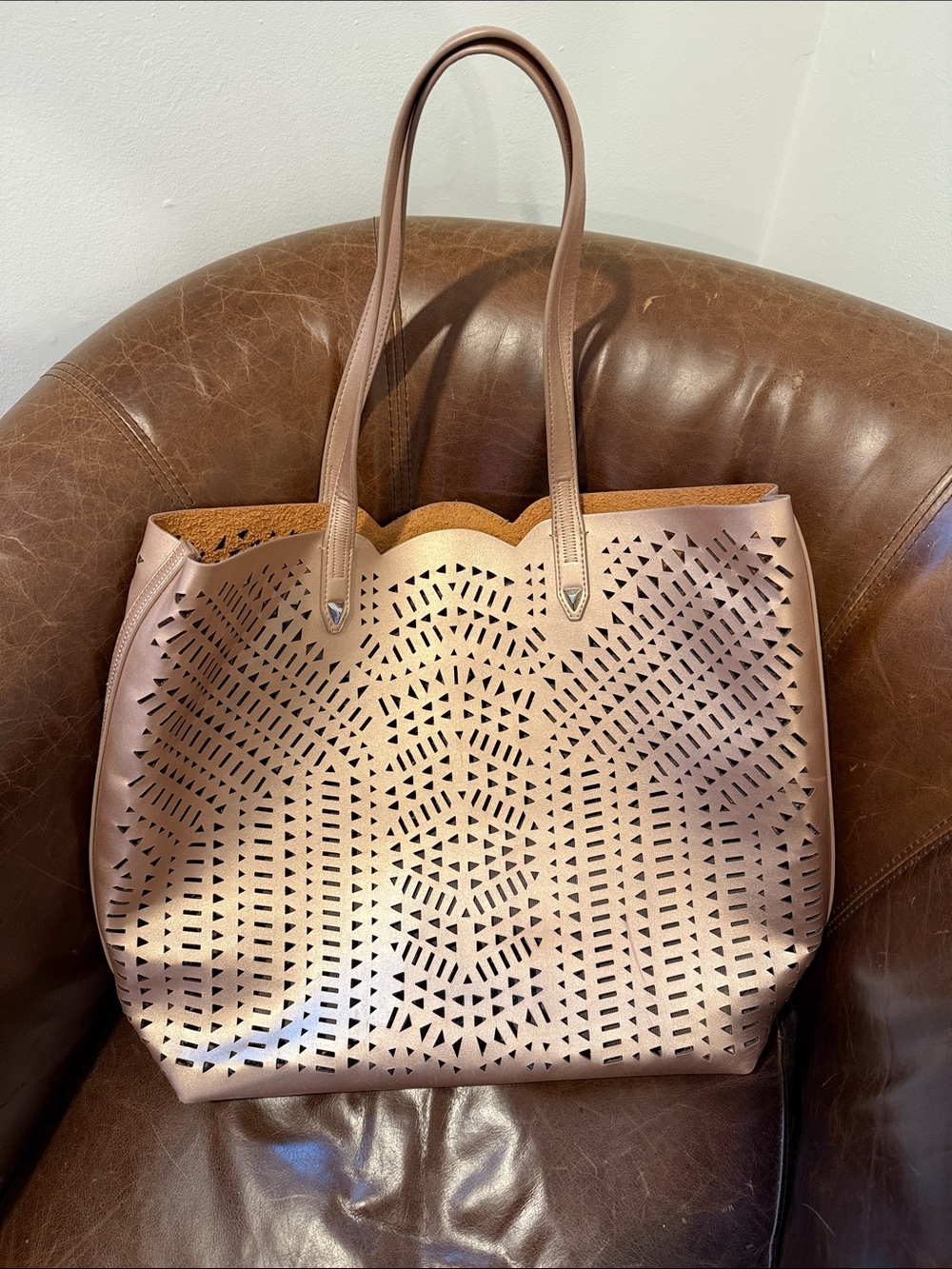Women’s Laser-Cut Tote Bag in Rose Gold Metallic vegan leather.